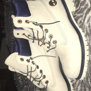 Slightly worn white and blue timberlands